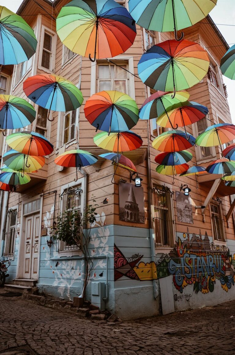 فنون الشارع في اسطنبول: تأمل في التعبير الفني الحضري 1 Multicolored Umbrella Hung Outside Brown Wooden House